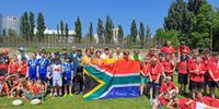 SA ambassador Shoayb Casoo and Leonid Deineko, head of Ukraine children’s rugby development -both wearing Springbok jerseys- and other officials, parents and players