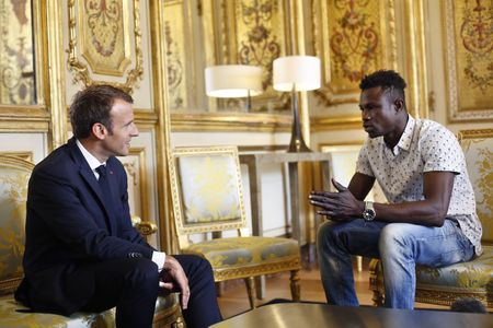Migrant 'Spiderman' who saved child praised by France's Macron