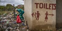 A worker collects glass bottles outside a liquor store. Shebeens and taverns are great sources of bottles. (Photo: Shiraaz Mohamed)