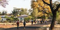 Children walk across town to Pomfret’s only school early on an October morning. Photo: Shaun Swingler
