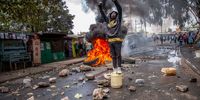 A Protestor of the Azimio la Umoja coalition stand on a water jerrycan celebrating victory during a nationwide mass protest in Kibera Slum of Nairobi, Kenya on March 20, 2023 in Nairobi, Kenya. Opposition leader and former Prime Minister Raila Odinga called for his supporters to protest today to pressure Kenyan President William Ruto over the cost of living. Odinga has also questioned the results of last year's presidential election. (Photo by Donwilson Odhiambo/Getty Images)
