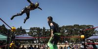 Wrestler 'Griffin' (L) jumps from the ropes onto his opponent during during a wrestling match at the Laerskool Morewag school in Johannesburg, South Africa, 24 August 2019. In the East Rand region of South Africa lives dedicated, passionate, amateur hardcore wrestling community, whose members find time between work and family to put on shows for their devoted following of fans at local community halls, high schools and motorcycle rallies. Hardcore wrestling is a form of professional wrestling where disqualifications, count-outs, and all other different rules do not apply. Matches are decided with the use of numerous dangerous items including tables, chairs, barbed wire, light tubes, shovels, chains, hammers, etc.  EPA-EFE/KIM LUDBROOK  ATTENTION: This Image is part of a PHOTO SET