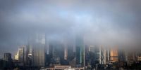SYDNEY, AUSTRALIA - JUNE 11: Fog covers buildings in the city as a ferry heads towards Circular Quay on June 11, 2021 in Sydney, Australia. Fog caused delays to ferry services and for drivers into the city due to reduced visibility.  (Photo by David Gray/Getty Images)