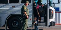 DEL RIO, TEXAS - SEPTEMBER 22: Migrants exit a Border Patrol bus and prepare to be received by the Val Verde Humanitarian Coalition after crossing the Rio Grande on September 22, 2021 in Del Rio, Texas. Thousands of immigrants, mostly from Haiti, seeking asylum have crossed the Rio Grande into the United States. Families are living in makeshift tents under the international bridge while waiting to be processed into the system. U.S. immigration authorities have been deporting planeloads of migrants directly to Haiti while others have crossed the Rio Grande back into Mexico. (Photo by Brandon Bell/Getty Images)